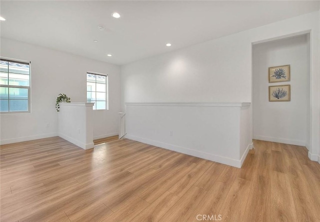 unfurnished room with light hardwood / wood-style flooring