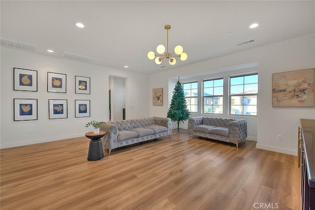 living room featuring light hardwood / wood-style flooring and a chandelier