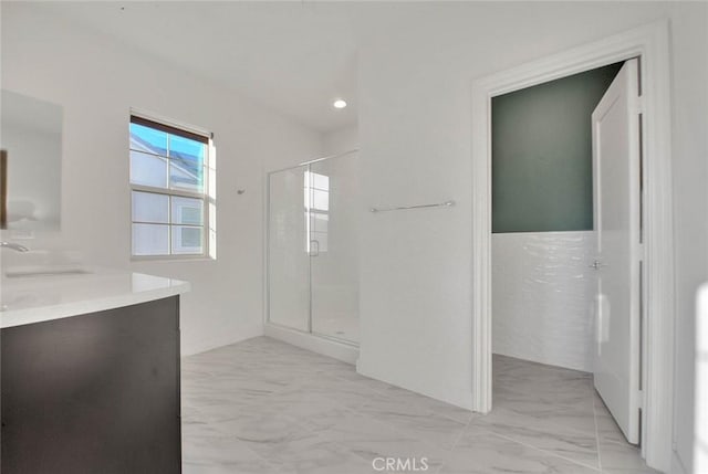 bathroom featuring vanity and a shower with door