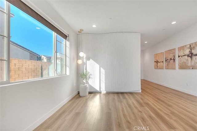 unfurnished room with light hardwood / wood-style floors