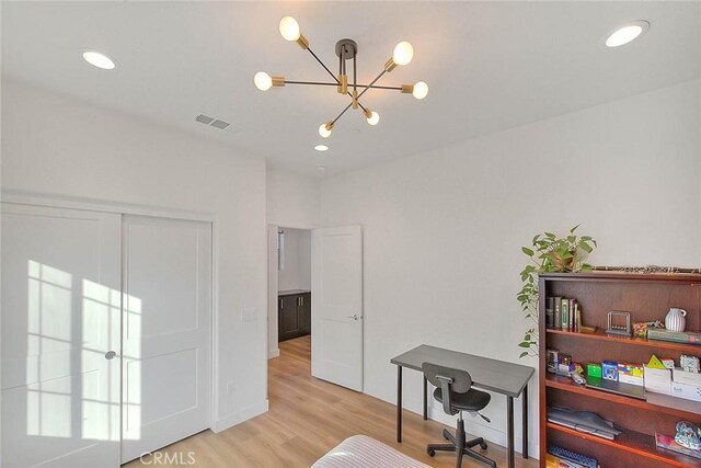 office area with an inviting chandelier and light wood-type flooring