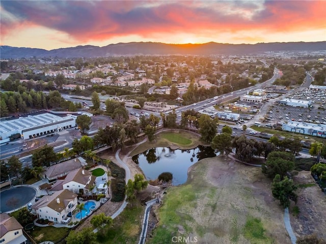 aerial view at dusk with a water and mountain view