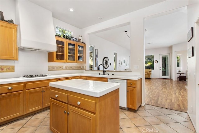 kitchen with a center island, light tile patterned floors, white appliances, and decorative backsplash