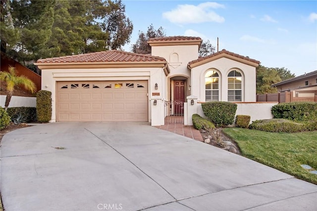 mediterranean / spanish home with a garage and a front yard