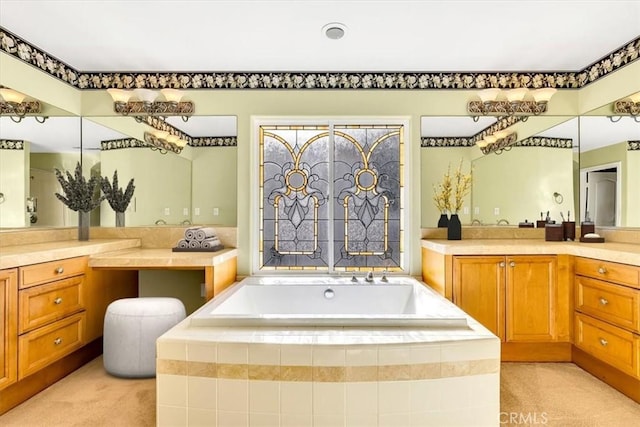 bathroom featuring vanity and a relaxing tiled tub