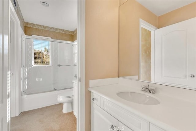 full bathroom with vanity, shower / bath combination with glass door, and toilet