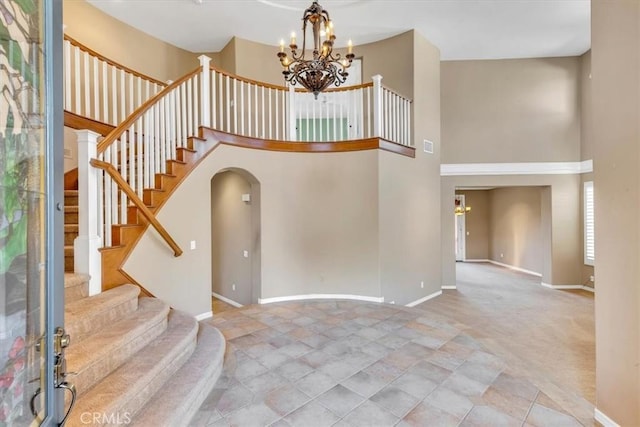 foyer entrance with a towering ceiling and an inviting chandelier