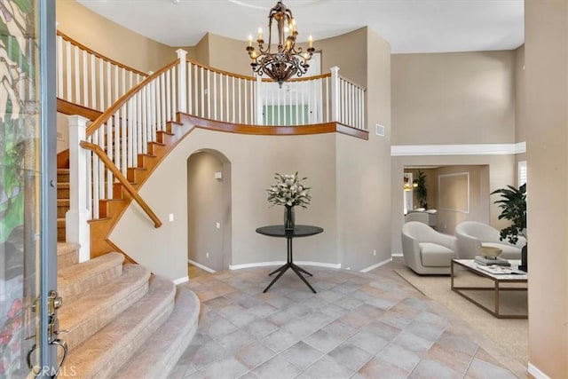 entryway featuring a notable chandelier and a high ceiling