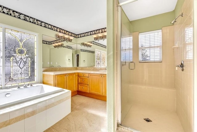 bathroom featuring vanity and shower with separate bathtub