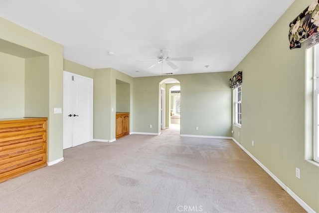 carpeted empty room with ceiling fan