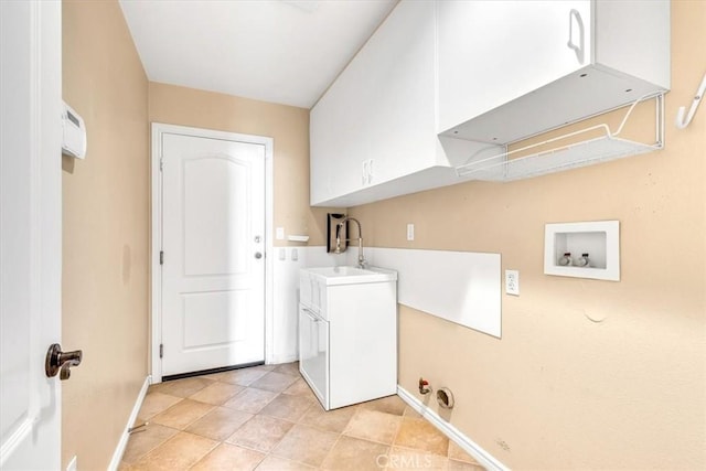 washroom featuring sink, hookup for a washing machine, and cabinets