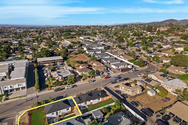 birds eye view of property with a mountain view