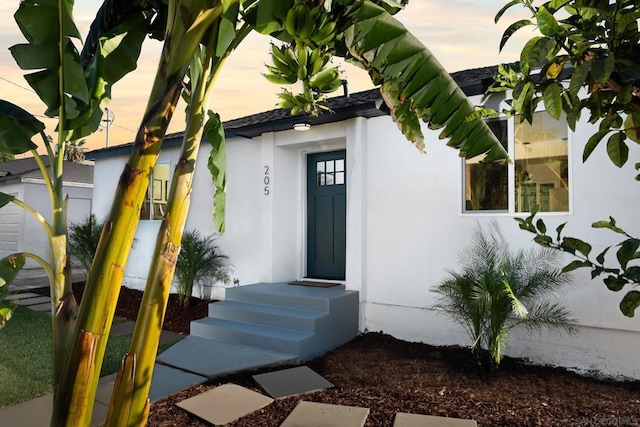 view of exterior entry at dusk