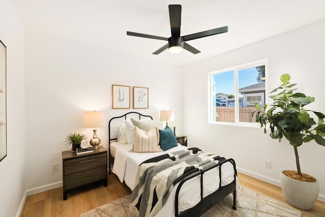 bedroom with light hardwood / wood-style floors and ceiling fan