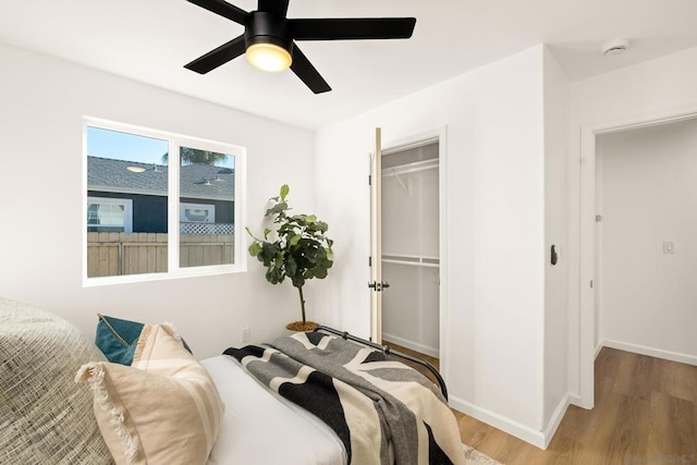 bedroom with hardwood / wood-style floors, a closet, and ceiling fan