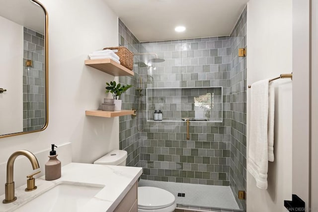 bathroom featuring vanity, toilet, and an enclosed shower