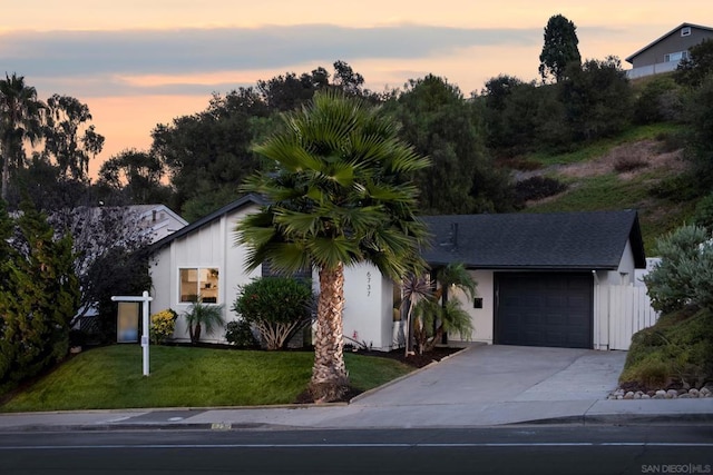 view of front facade with a garage and a lawn