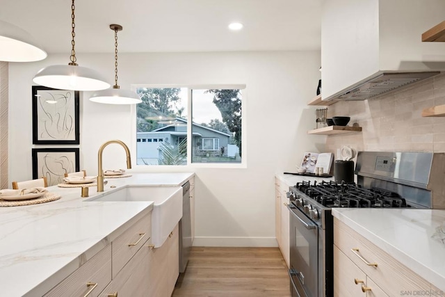 kitchen featuring hanging light fixtures, backsplash, stainless steel appliances, light stone counters, and exhaust hood