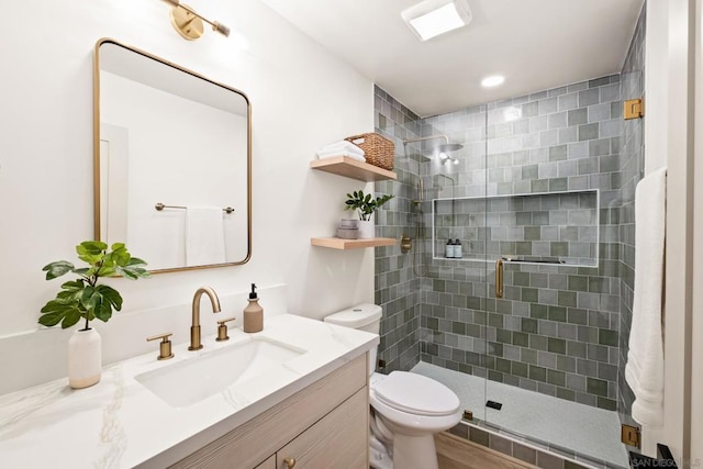 bathroom with vanity, walk in shower, and toilet