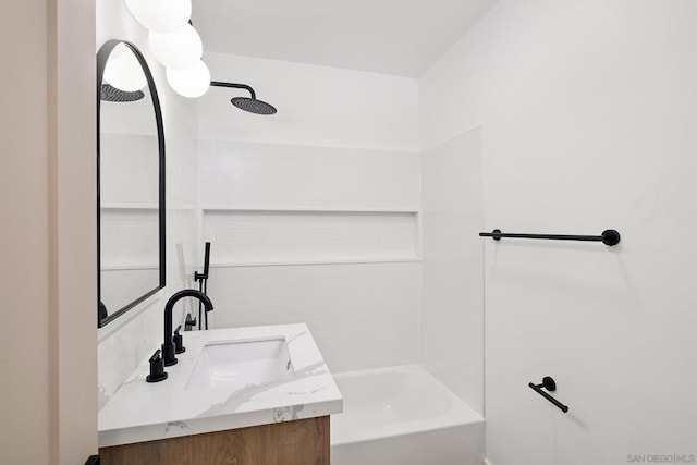 bathroom featuring washtub / shower combination and vanity