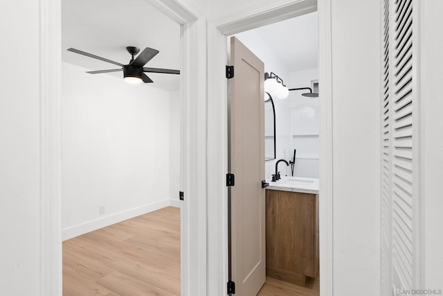 bathroom with wood-type flooring, vanity, and ceiling fan