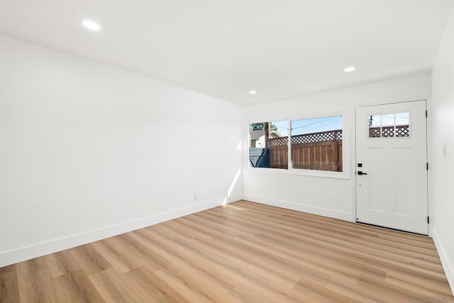 entryway with a healthy amount of sunlight and light hardwood / wood-style floors