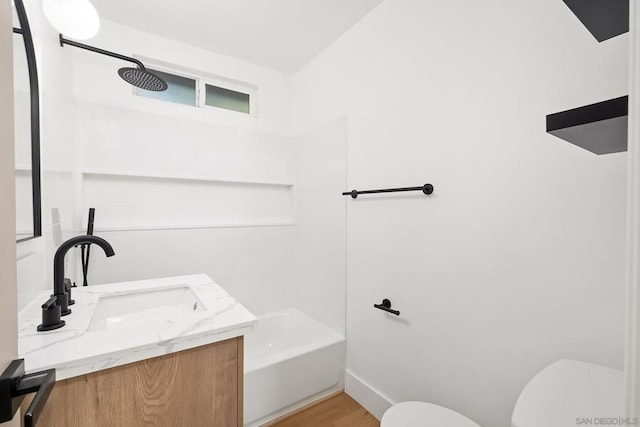 full bathroom with bathtub / shower combination, vanity, toilet, and hardwood / wood-style floors