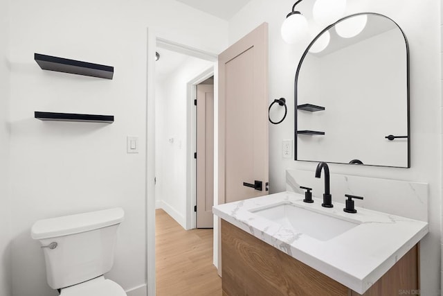 bathroom featuring vanity, toilet, and wood-type flooring