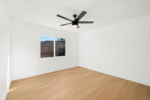 spare room with ceiling fan and light wood-type flooring