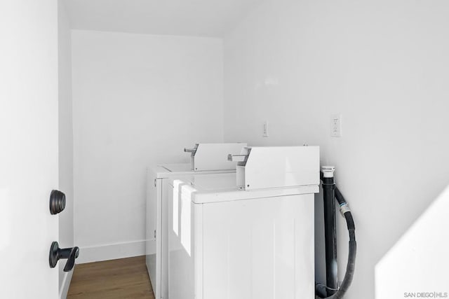 laundry room featuring wood-type flooring and independent washer and dryer