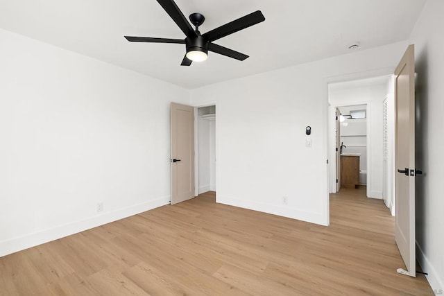 unfurnished bedroom featuring ceiling fan, a closet, and light wood-type flooring