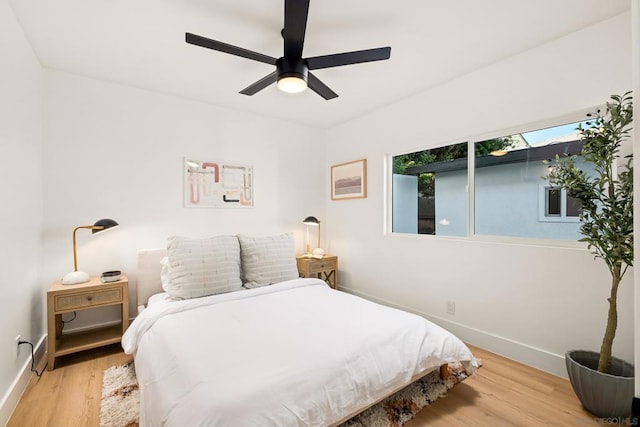 bedroom with ceiling fan and light hardwood / wood-style flooring