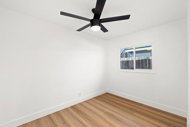 empty room with hardwood / wood-style flooring and ceiling fan