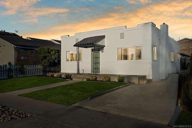 view of front of home with a lawn