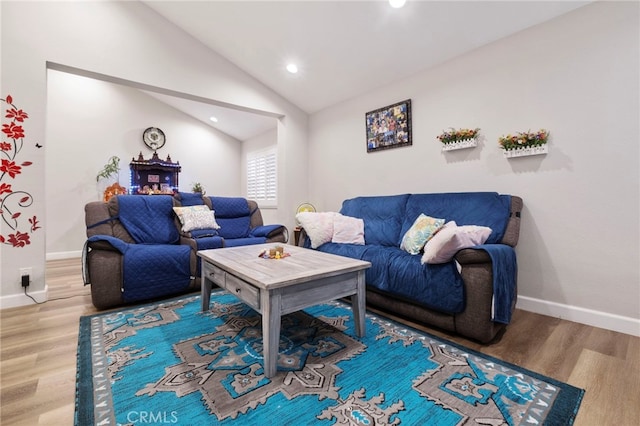 living room with lofted ceiling and hardwood / wood-style flooring