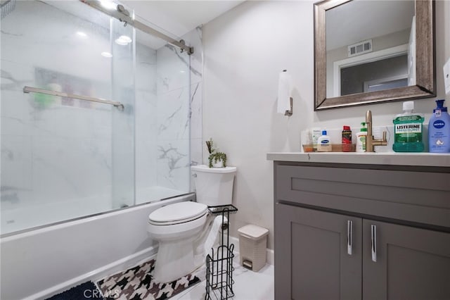 full bathroom featuring toilet, vanity, and bath / shower combo with glass door