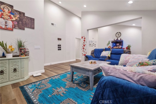 living room featuring hardwood / wood-style flooring and vaulted ceiling