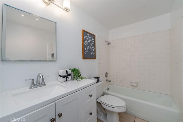 full bathroom featuring tiled shower / bath combo, vanity, tile patterned floors, and toilet