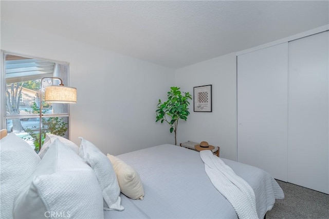 carpeted bedroom with a closet