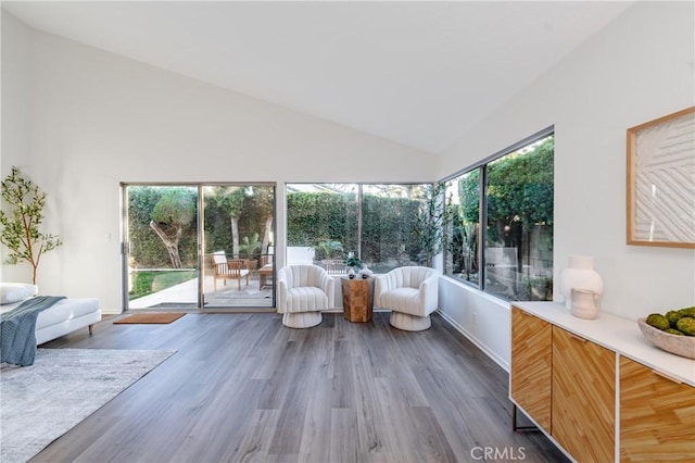 unfurnished sunroom featuring lofted ceiling and a wealth of natural light