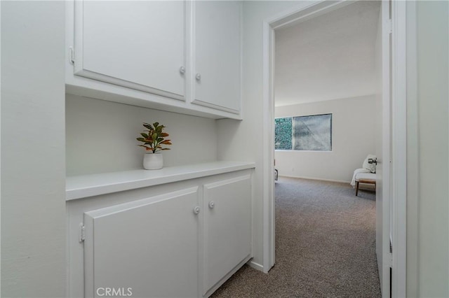 hall featuring light colored carpet