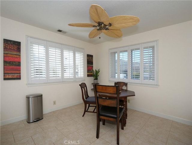 tiled dining area featuring ceiling fan