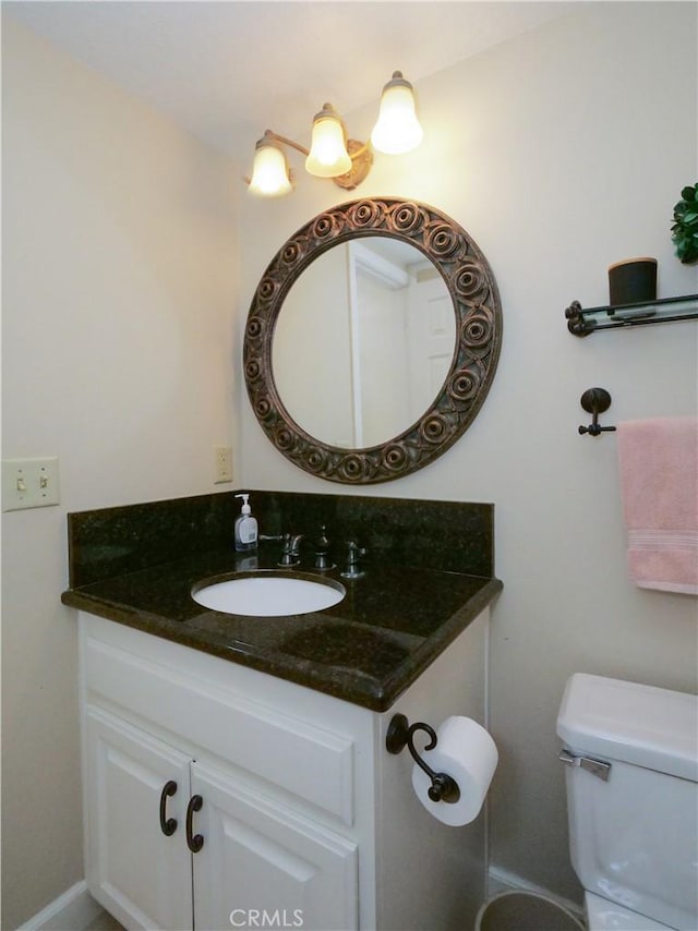 bathroom featuring vanity and toilet