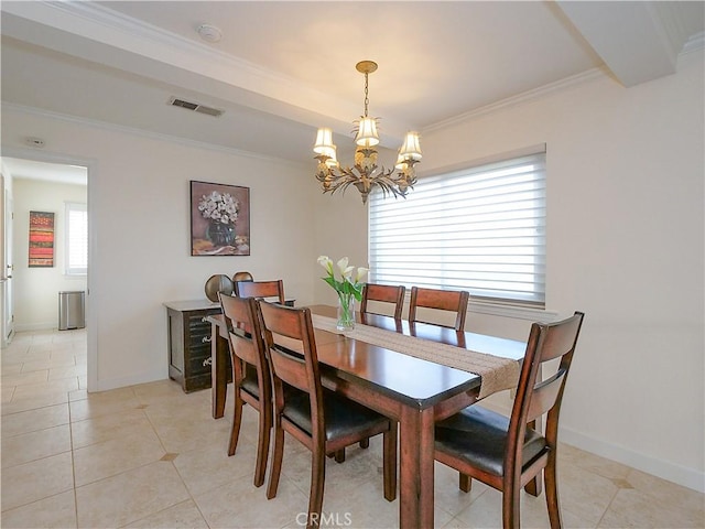 dining area featuring crown molding, a chandelier, and light tile patterned floors