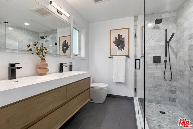 bathroom with a shower with door, vanity, tile patterned flooring, and toilet