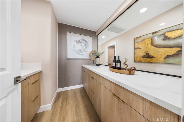 bathroom with wood-type flooring and vanity