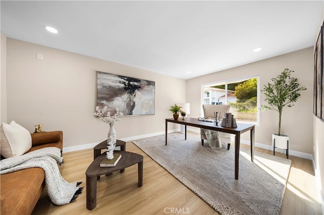 home office with light hardwood / wood-style floors