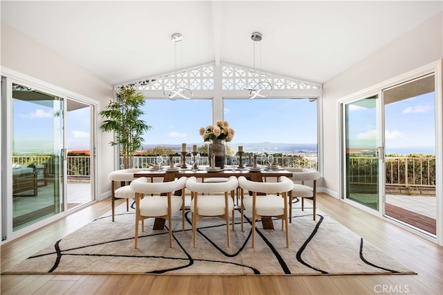 sunroom / solarium with a mountain view and vaulted ceiling with beams