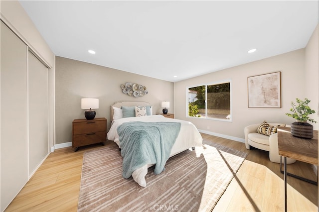 bedroom with wood-type flooring and a closet