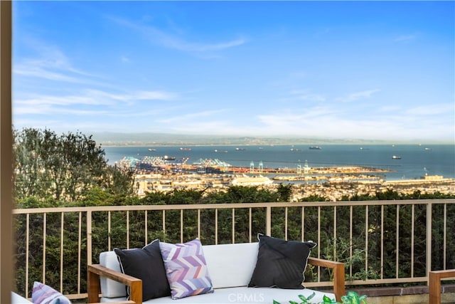 balcony featuring a beach view and a water view